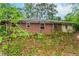 Modest brick home with overgrown yard, offering a renovation opportunity for the discerning buyer at 2322 Paces Ferry Se Rd, Smyrna, GA 30080