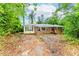 View of the property, showing the exterior and overgrown yard with potential for revitalization at 2322 Paces Ferry Se Rd, Smyrna, GA 30080