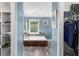 Stylish bathroom with a soaking tub set against blue walls and contrasting dark wood paneling at 380 Kendrick Se Ave, Atlanta, GA 30315