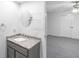 This bathroom features a gray vanity, a granite countertop, and a round mirror at 380 Kendrick Se Ave, Atlanta, GA 30315