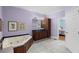 Spacious bathroom showcases a corner tub, wood vanity with dark countertop, and decorative art at 380 Kendrick Se Ave, Atlanta, GA 30315