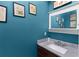 Stylish powder room with granite countertop and dark blue accent wall with artwork at 380 Kendrick Se Ave, Atlanta, GA 30315