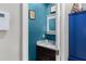 Powder room with vanity, granite countertop, blue accent wall, and artwork at 380 Kendrick Se Ave, Atlanta, GA 30315
