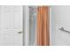 A bright bathroom with a shower featuring a rod and orange curtain at 380 Kendrick Se Ave, Atlanta, GA 30315