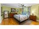 Comfortable bedroom features hardwood floors, a ceiling fan, and windows offering natural light and green views at 380 Kendrick Se Ave, Atlanta, GA 30315