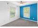 Bright bedroom featuring blue accent wall and large windows with lush green views at 380 Kendrick Se Ave, Atlanta, GA 30315