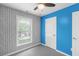 Bedroom features patterned accent wall, neutral carpet, and a ceiling fan at 380 Kendrick Se Ave, Atlanta, GA 30315