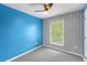 Bedroom featuring patterned accent wall, neutral carpet, and a ceiling fan at 380 Kendrick Se Ave, Atlanta, GA 30315