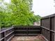 An empty deck with a wooden floor and brown wooden railings, with lots of trees in the background at 380 Kendrick Se Ave, Atlanta, GA 30315