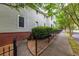Charming exterior of a well-maintained townhome with brick accents, a walkway, and lush landscaping at 380 Kendrick Se Ave, Atlanta, GA 30315
