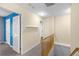 Light-filled hallway with neutral walls and wooden railings leading to the next floor at 380 Kendrick Se Ave, Atlanta, GA 30315