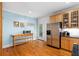 Bright kitchen features stainless steel refrigerator, hardwood floors, and light blue walls at 380 Kendrick Se Ave, Atlanta, GA 30315