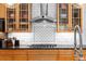 Well-equipped kitchen with stainless steel range hood and wooden cabinetry with glass door fronts at 380 Kendrick Se Ave, Atlanta, GA 30315