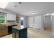 Large kitchen with a blue island, granite counters, lots of cabinets, and backyard access at 380 Kendrick Se Ave, Atlanta, GA 30315