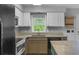 Kitchen featuring a window over the sink, granite countertops, and stainless appliances at 380 Kendrick Se Ave, Atlanta, GA 30315