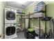 Laundry room with stackable washer and dryer and metal storage racks at 380 Kendrick Se Ave, Atlanta, GA 30315