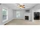 Bright living room featuring a fireplace, large windows, and an open layout to the kitchen, ideal for entertaining at 380 Kendrick Se Ave, Atlanta, GA 30315