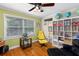 Sitting room with hardwood floors, a window, and a white bookcase filled with books and decorative items at 380 Kendrick Se Ave, Atlanta, GA 30315