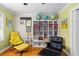 This sitting room features hardwood floors, a book case filled with books, and uniquely designed art and decor at 380 Kendrick Se Ave, Atlanta, GA 30315