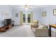 Bright sitting room with neutral carpeting and double doors to the outside at 380 Kendrick Se Ave, Atlanta, GA 30315
