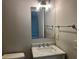 Bathroom featuring marble countertop, modern vanity, sleek mirror and stylish lighting at 486 Victoria Rd, Woodstock, GA 30189