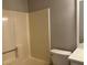 Bathroom with neutral walls featuring a shower-tub combo and a classic toilet-vanity setup at 486 Victoria Rd, Woodstock, GA 30189