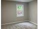 Cozy bedroom with neutral walls and carpet, brightened by a window with natural light at 486 Victoria Rd, Woodstock, GA 30189