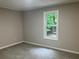 Inviting bedroom with neutral walls and carpet, offering a serene view of the outdoor landscape at 486 Victoria Rd, Woodstock, GA 30189