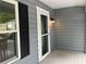 Charming entrance with a storm door, black shutters, neutral siding, and a lovely exterior light fixture at 486 Victoria Rd, Woodstock, GA 30189