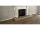 Living room featuring a classic fireplace with tile hearth and white mantel at 486 Victoria Rd, Woodstock, GA 30189