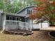 Charming two-story home with a covered front porch, white railings, and a two-car garage at 486 Victoria Rd, Woodstock, GA 30189