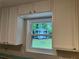 Bright kitchen featuring white cabinets and a window looking out onto the yard at 486 Victoria Rd, Woodstock, GA 30189