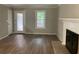 Living room with laminate flooring, fireplace, and natural light at 486 Victoria Rd, Woodstock, GA 30189