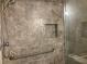 Contemporary tiled shower with a convenient grab bar and built-in niche at 486 Victoria Rd, Woodstock, GA 30189