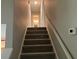 View of carpeted stairway with white railing leading to the upper level at 486 Victoria Rd, Woodstock, GA 30189