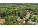 Aerial view of the house surrounded by dense trees in a residential neighborhood at 1125 Harvest Brook Way, Lawrenceville, GA 30043