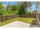 Fenced backyard featuring a concrete patio and grassy area at 1125 Harvest Brook Way, Lawrenceville, GA 30043