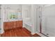 Bathroom with a double sink vanity, bathtub, and a walk-in shower at 1125 Harvest Brook Way, Lawrenceville, GA 30043