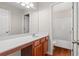 Bathroom featuring a vanity with cabinets and a shower-tub combo at 1125 Harvest Brook Way, Lawrenceville, GA 30043