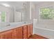 Bathroom featuring a double sink vanity and bathtub with lots of light at 1125 Harvest Brook Way, Lawrenceville, GA 30043