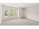 Bright bedroom featuring large window and neutral walls at 1125 Harvest Brook Way, Lawrenceville, GA 30043
