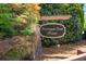 Community sign for Kensington Creek Manor surrounded by greenery and brick at 1125 Harvest Brook Way, Lawrenceville, GA 30043