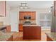 Well-equipped kitchen featuring granite countertops, a center island, and stainless steel appliances at 1125 Harvest Brook Way, Lawrenceville, GA 30043
