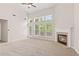 Comfortable living room with high ceilings, fan, and many large windows at 1125 Harvest Brook Way, Lawrenceville, GA 30043