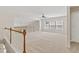 Bright and airy loft area with ample natural light and carpet flooring at 1125 Harvest Brook Way, Lawrenceville, GA 30043