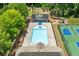 Aerial view of pool and tennis courts, perfect for relaxation and friendly competition on sunny days at 1125 Harvest Brook Way, Lawrenceville, GA 30043