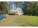 View of the home's backyard featuring a large lawn and wooded perimeter at 1493 Martin Nash Sw Rd, Lilburn, GA 30047