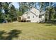 Spacious backyard featuring mature trees, well-maintained lawn and patio at 1493 Martin Nash Sw Rd, Lilburn, GA 30047