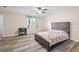 Bright bedroom boasts wood floors, ceiling fan, and plenty of natural light at 1493 Martin Nash Sw Rd, Lilburn, GA 30047