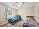 Bedroom with twin beds, luxury vinyl plank flooring, ceiling fan and window at 1493 Martin Nash Sw Rd, Lilburn, GA 30047